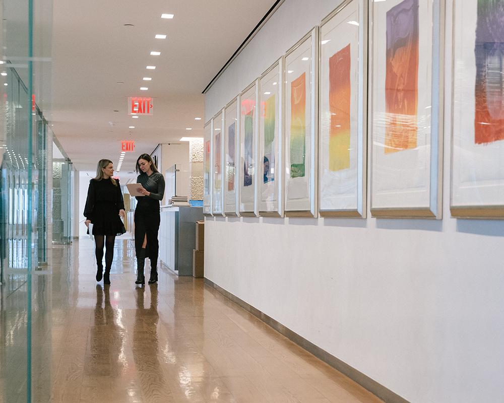 Baron Capital Employees Walking Down a Hall