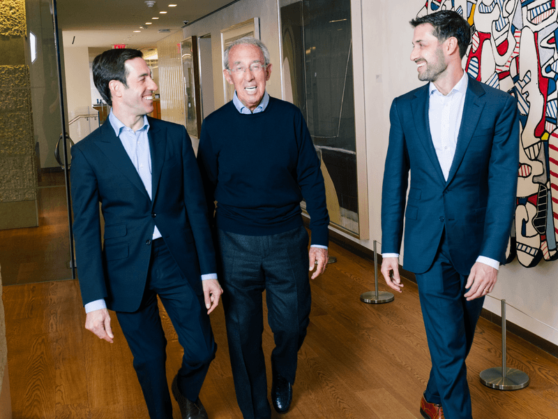 Ron Baron, Michael Baron, and David Baron walking in Baron Capital's office